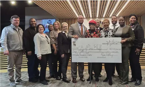  ?? (Pine Bluff Commercial/Eplunus Colvin) ?? The city of Pine Bluff received a $1 million check for the Sixth and Main Street project from the Pine Bluff Urban Renewal Agency and Go Forward Pine Bluff during Monday’s city council meeting.