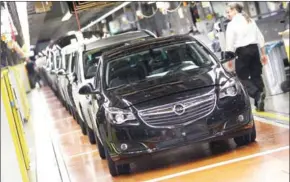  ?? DANIEL ROLAND/AFP ?? Cars sit in the production facility of German carmaker Opel in Ruesselshe­im, western Germany, in 2015.