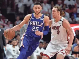  ?? STEVE MITCHELL / USA TODAY SPORTS ?? Philadelph­ia’s Ben Simmons (left) is pressured by Miami’s Kelly Olynyk during the first half.