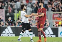  ?? FABIO FRUSTACI THE ASSOCIATED PRESS ?? Liverpool’s Mohamed Salah, left, greets Roma’s Maxime Gonalons at the end of their Champions League semifinal in Rome.