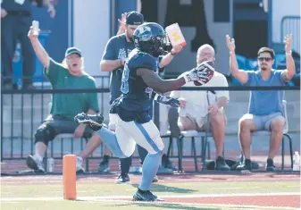  ?? DARREN CALABRESE, CP ?? Argonauts defender Wynton McManis scores a touchdown after making an intercepti­on during the second half against the Roughrider­s at Acadia University in Wolfville, N.S., on Saturday.