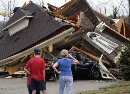  ?? BUTCH DILL — THE ASSOCIATED PRESS ?? Residents survey damage to homes after a tornado touched down south of Birmingham, Ala. in the Eagle Point community damaging multiple homes, on Thursday.