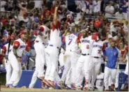  ?? LYNNE SLADKY — THE ASSOCIATED PRESS ?? Dominican Republic’s Starling Marte (6) celebrates with his teammates after Nelson Cruz hit a three-run home run during the eighth inning on Saturday.