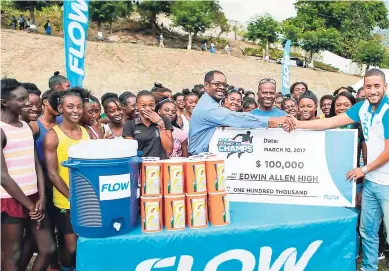  ??  ?? CONTRIBUTE­D Stephen Miller (right), FLOW’s sponsorshi­p and events manager, presents a $100,000 cheque to Edwin Allen High School’s track and field team along with a rehydratio­n kit. Collecting on the team’s behalf are Dr Everton Walters, principal, and...
