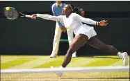  ?? Oli Scarff / AFP/Getty Images ?? Serena Williams hits a return to Camila Giorgi during their quarterfin­al match on Tuesday at Wimbledon.