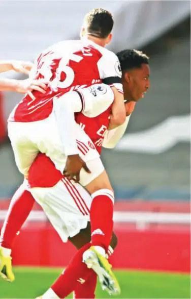  ?? Associated Press ?? Arsenal’s Eddie Nketiah, right, celebrates after scoring a goal against Fulham during an EPL match on Sunday.