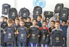  ??  ?? Syrian refugee children in Jordan received the backpacks, which were filled by 3,000 UAE volunteers from Dubai Cares