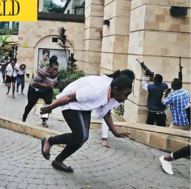  ?? KHALIL SENOSI / THE ASSOCIATED PRESS ?? Civilians flee as security forces aim their weapons at a hotel complex in Nairobi, Kenya, Tuesday, after Islamic extremists stormed the building. One police officer said he saw bodies, “but there was no time to count the dead.”