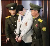  ?? AP/JON CHOL JIN ?? North Korean officers carry Otto Warmbier into court on March 16, 2016, where he was sentenced to 15 years of hard labor. He fell into a coma that night for reasons that were never explained.