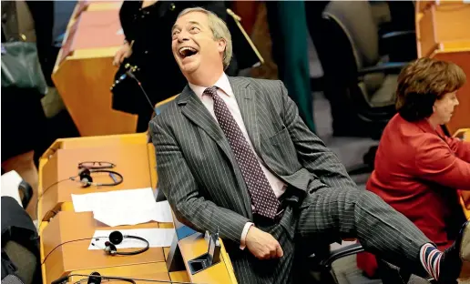  ?? AP ?? Brexit Party leader Nigel Farage shows off his Union flag socks during the plenary session at the European Parliament in Brussels.