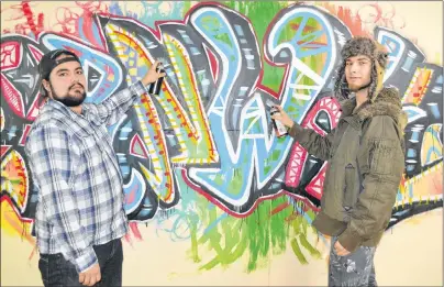  ?? MAUREEN COULTER/THE GUARDIAN ?? Trenton Smith, left, and Nolan Peters have brightened up the Cornwall Youth Centre by spray-painting a 40-foot section with the word ‘Cornwall’ in graffiti writing along with various cartoon characters.