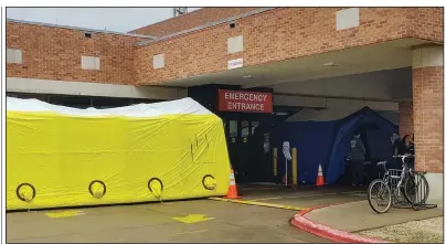  ?? (Arkansas Democrat-Gazette/Jeannie Roberts) ?? Conway Regional Health System has set up tents and has medical staff waiting Thursday in front of the hospital’s emergency room door to screen people for coronaviru­s symptoms. A hospital spokesman said the health system has implemente­d screenings for all visitors, patients, physicians and employees.