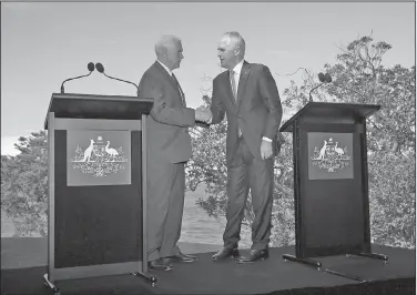  ?? AP/RICK RYCROFT ?? U.S. Vice President Mike Pence (left) and Australian Prime Minister Malcolm Turnbull shake hands following a joint news conference Saturday in Sydney. Pence and Turnbull are joining forces in urging China to do more to pressure North Korea to drop its...