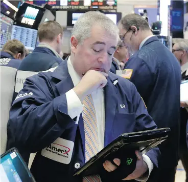  ?? RICHARD DREW / THE ASSOCIATED PRESS ?? Trader Edward McCarthy on the floor of the New York Stock Exchange. Citigroup says the next downturn in stocks should be a signal to buy.