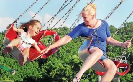  ?? JOHN STRICKLER — DIGITAL FIRST MEDIA ?? Kristi Verrechio and her daughter Kiernan Verrechio have fun together riding the swings at Daniel Boone High School’s Blazer Days carnival Thursday, June 30.