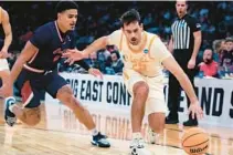  ?? FRANK FRANKLIN II/AP ?? Tennessee’s Santiago Vescovi controls while guarded by Florida Atlantic’s Bryan Greenlee during Thursday night’s game.