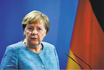  ?? John Macdougall / AFP / Getty Images ?? Chancellor Angela Merkel announced she will step down as leader of her center-right party.