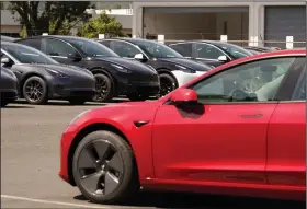  ?? (AP file photo) ?? Electric cars are parked at a Tesla delivery location and service center in Corte Madera, Calif.