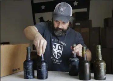  ?? SETH WENIG—ASSOCIATED PRESS ?? In this March 4, 2019, photo, Jamie Adams shows some intact beer bottles recovered from the shipwreck of the SS Oregon at his St. James Brewery in Holbrook, N.Y. Adams created an ale called Deep Ascent using the yeast from the bottles recovered from the Liverpool-to-New York luxury liner that sank off Fire Island in 1886.