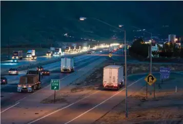  ?? ?? Trucks rush up and down Interstate 5, south of Bakersfiel­d, delivering products and supplies to the Tejon distributi­on center and throughout the West Coast.