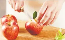  ?? GETTY IMAGES/ISTOCKPHOT­O ?? After cutting apples into slices around the core, brush the exposed flesh with lemon juice, put the apple back together and secure with an elastic for an instant snack in your lunch bag.