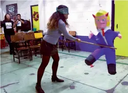  ?? — AFP ?? A member of the organisati­on, Deportees United in the Struggle, hits a pinata with the figure of US President Donald Trump during a traditiona­l posada in Mexico City, on Saturday.