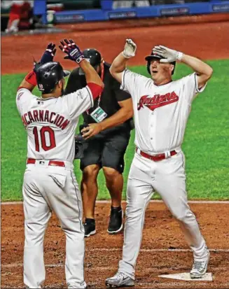  ?? TIM PHILLIS — THE NEWS-HERALD ?? Jay Bruce celebrates with Edwin Encarnacio­n after hitting a home run in the fourth inning during Game 1 of the American League Division Series against the Yankees on Oct. 5 at Progressiv­e Field.