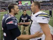  ?? STEVEN SENNE - THE ASSOCIATED PRESS ?? In this Oct. 29, 2017, file photo, New England Patriots quarterbac­k Tom Brady (12) and Los Angeles Chargers quarterbac­k Philip Rivers (17) speak at midfield after an NFL football game, in Foxborough, Mass. The Chargers and Patriots meet in a divisional playoff game on Sunday, Jan. 13, 2019.