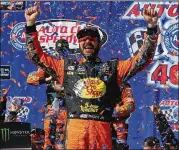  ?? SARAH CRABILL / GETTY IMAGES ?? Reigning Cup champion Martin Truex Jr. celebrates after winning Sunday’s Auto Club 400 by 11 seconds over Kyle Larson. Kyle Busch was third.