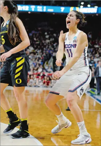  ?? SEAN D. ELLIOT/THE DAY ?? UConn’s Kia Nurse celebrates after hitting a 3-pointer over Oregon’s Maite Cazorla, left, during the first half of Monday’s Bridgeport Regional championsh­ip game at Webster Bank Arena. The Huskies routed the Ducks 90-52 and earned a trip to the Final...