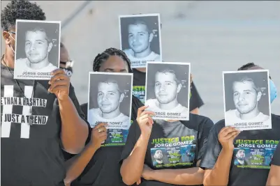  ?? Ellen Schmidt Las Vegas Review-journal @ellenkschm­idttt ?? People hold Jorge Gomez’s photos at a news conference Wednesday in Las Vegas. Gomez was fatally shot by police in June.