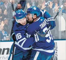  ?? KEVIN SOUSA NHLI VIA GETTY IMAGES ?? John Tavares of the Maple Leafs celebrates his 13th goal of the season with Mitch Marner in the second period against the Columbus Blue Jackets at the Scotiabank Arena in Toronto on Monday. For a Rosie DiManno column on Tavares, see Page S3.