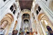  ??  ?? Paintings of St Ethelflaed­a, an abbess, and her candle created by artist Christophe­r Gollon for an exhibition held in Romsey Abbey, left, are said to be putting people off their prayers