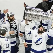  ?? ASSOCIATED PRESS FILE PHOTO ?? Tampa Bay Lightning’s Nikita Kucherov (86) hoists the Stanley Cup after defeating the Dallas Stars in the 2020 Stanley Cup hockey finals in Edmonton, Alberta. Kucherov is expected to miss the entire regular season because of a hip injury that requires surgery. General manager Julien BriseBois ruled out Kucherov for the 56-game season that begins Jan. 13 and ends May 8.