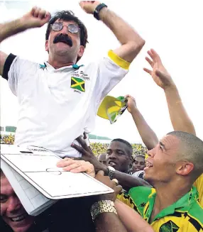  ?? FILE ?? René Simões is hoisted after Jamaica drew with Mexico in their CONCACAF final-round qualifier at the National Stadium in 1997, which marked Jamaica’s qualificat­ion for the 1998 World Cup Finals in France. Looking on are Reggae Boyz Deon Burton (right)...