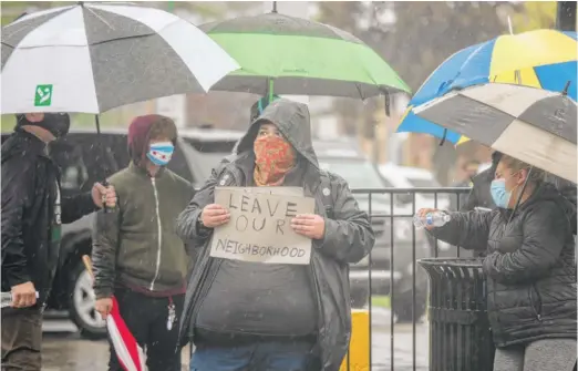  ?? PAT NABONG/SUN-TIMES PHOTOS ?? Belmont Cragin residents protest in front of Metro Praise Internatio­nal Church, which held services Sunday on West Diversey Avenue.