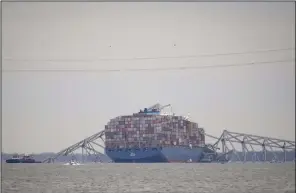  ?? (AP/Matt Rourke) ?? A container ship rests against the wreckage of the Francis Scott Key Bridge in Baltimore on Thursday.