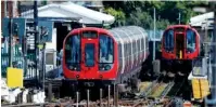  ?? THE ASSOCIATED PRESS ?? A police officer on Friday walks beside a train where an explosion happened. Police said they are investigat­ing the incident as a terrorist attack at Parsons Green subway station in London.