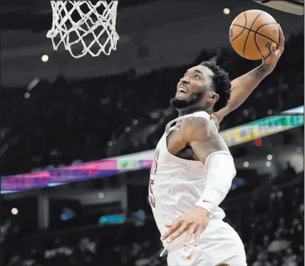  ?? Sue Ogrocki The Associated Press ?? Cleveland Cavaliers guard Donovan Mitchell goes up for a dunk in the second half Monday against the Kings. The Cavs are 19-4 since Dec. 16. “Everybody’s risen to the occasion,” Mitchell said.