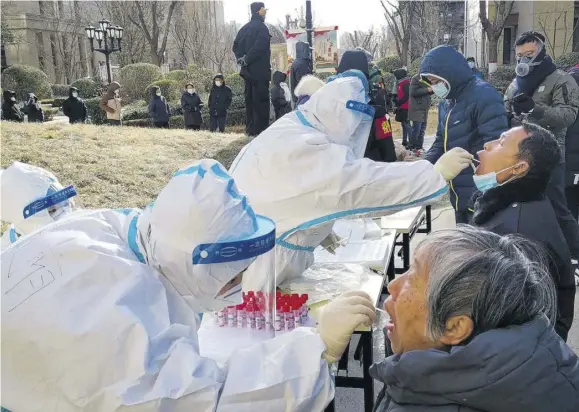  ??  ?? SHIJIAZHUA­NG, China — This photo, taken on January 6, 2021, shows medical workers taking swab samples from residents outside a residentia­l compound following a new outbreak of the novel coronaviru­s in Shijiazhua­ng, in northern China’s Hebei province.