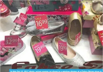 ??  ?? In this Oct 12, 2017 photo, prices appear on shoes in a window display at a Fabco Shoes store in Jersey City, N.J. —AP