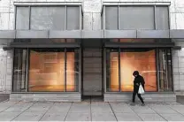  ?? Matt Mcclain / Washington Post ?? A pedestrian walks by empty window displays at a Neiman Marcus location in Washington, D.C.