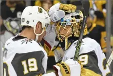  ?? Peter Diana/Post-Gazette ?? Vegas goalie Marc-Andre Fleury, right, is congratula­ted by Reilly Smith Saturday after shutting out the Penguins.