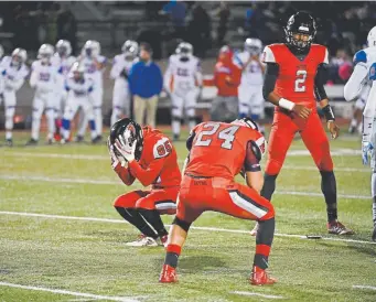  ?? Andy Cross, The Denver Post ?? Eaglecrest kicker Taylor Gomez (85) holds his head in his hands after missing a field goal late in the fourth quarter against the Cherry Creek on Friday.