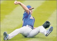  ?? AP ?? ANY MEANS POSSIBLE: Pitching prospect Matt Allan makes a throw from the seat of his pants during Monday’s game.