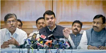  ?? — PTI ?? Maharashtr­a CM Devendra Fadnavis flanked by senior BJP leader Sudhir Mungantiwa­r (L) and Maharashtr­a BJP president Chandrakan­t Patil (R) in Mumbai on Friday.