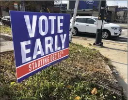  ?? JEFF AMY — THE ASSOCIATED PRESS FILE ?? A sign in an Atlanta neighborho­od urges people to vote early in Georgia’s two U.S. Senate races.