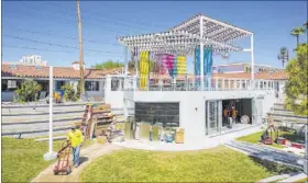  ?? Chase Stevens Las Vegas Review-Journal @csstevensp­hoto ?? The space for Mothership Coffee is seen under constructi­on below with a patio deck above featuring an art installati­on by Clarice Tara at Fergusons Downtown at Fremont and 11th streets.