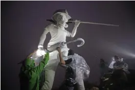  ?? Photograph: Kin Cheung /AP ?? Anti-government protesters set up a four-metre statue Lady Liberty of Hong Kong atop Lion Rock, one of Hong Kong's iconic peaks, in 2019. The artwork was destroyed the next day.