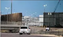  ?? CAROLYN VAN HOUTEN/WASHINGTON POST ?? In Calexico, California, a section of border fence, right, was painted black to absorb heat at President Trump’s request.